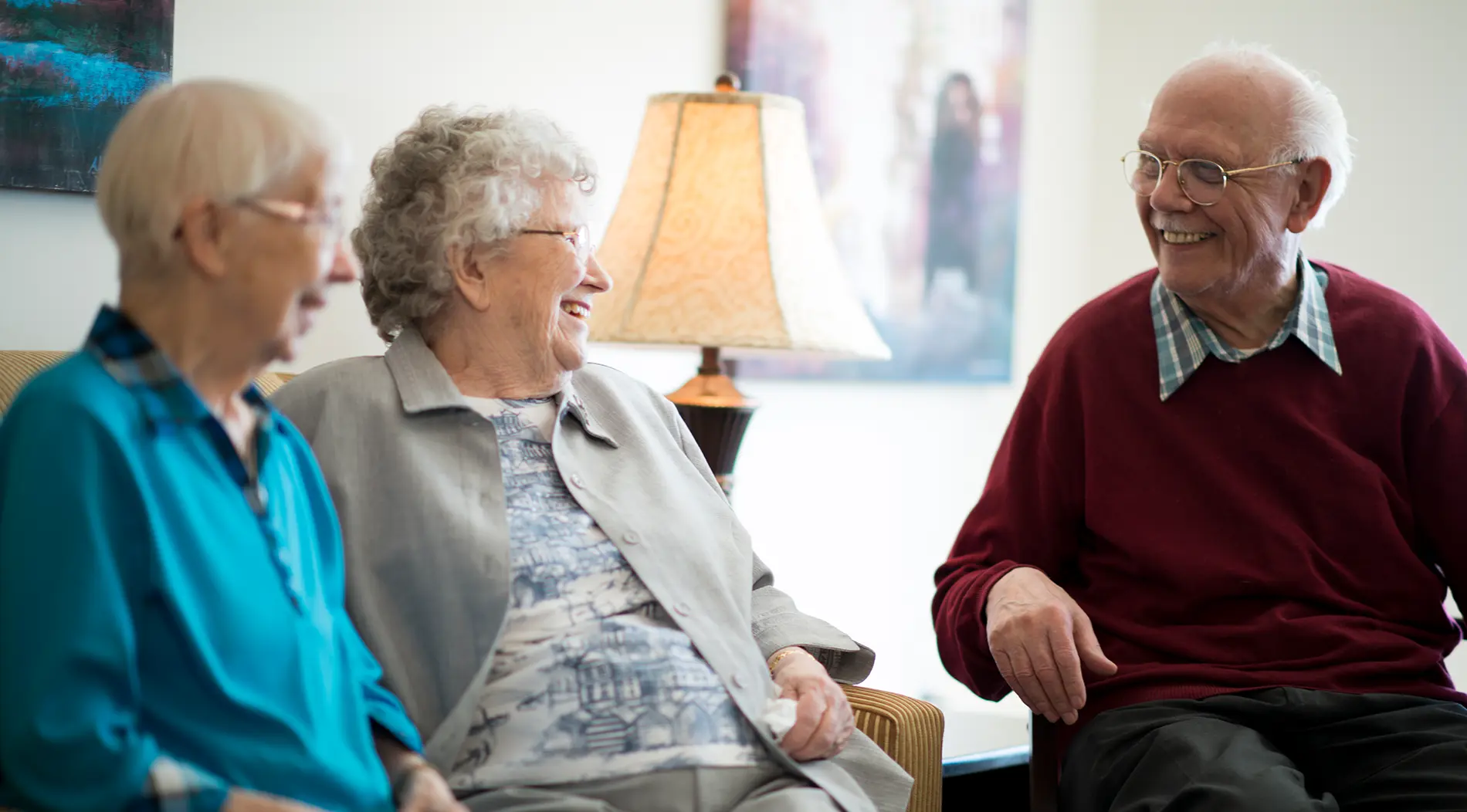 senior-placement_1900x1052 A group of older adults who utilized senior placement services in Pima County laugh together as they enjoy cake and coffee.